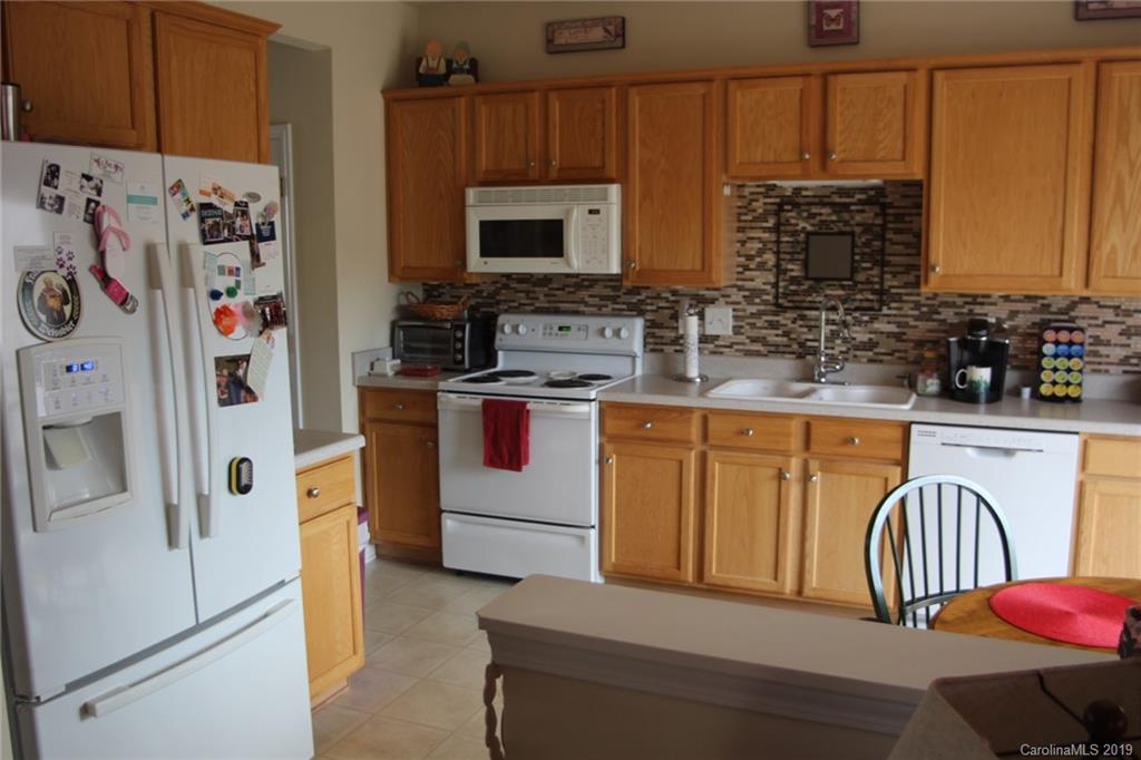 7539 Bluff Point Lane Denver, NC 28037 - Photo 16 of 30 a kitchen with stainless steel appliances granite countertop a refrigerator a stove a sink and a microwave