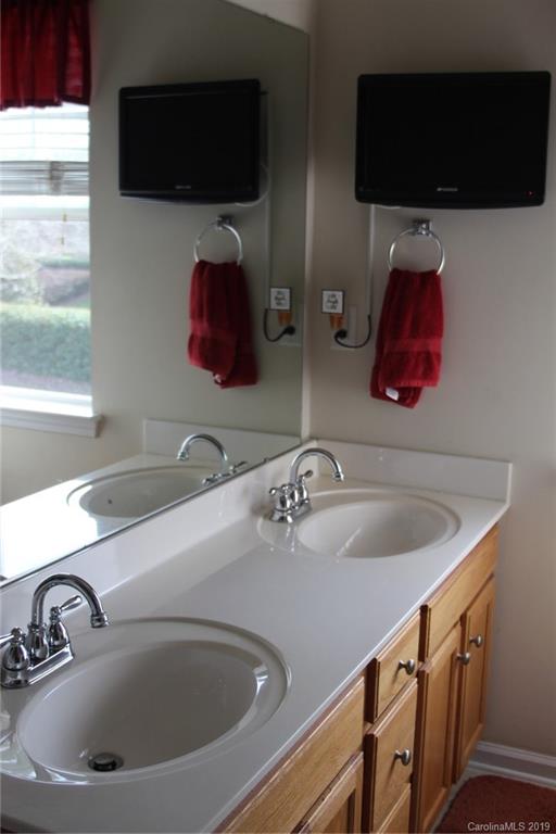 7539 Bluff Point Lane Denver, NC 28037 - Photo 21 of 30 a bathroom with a sink and a mirror