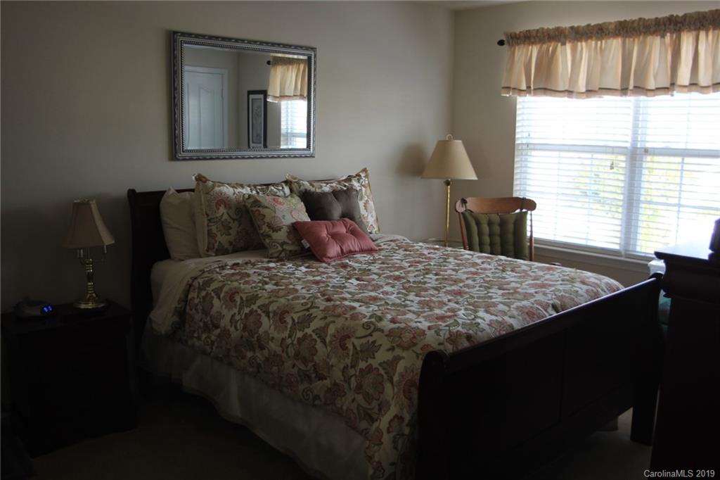 7539 Bluff Point Lane Denver, NC 28037 - Photo 23 of 30 a bed sitting in a bedroom next to a window