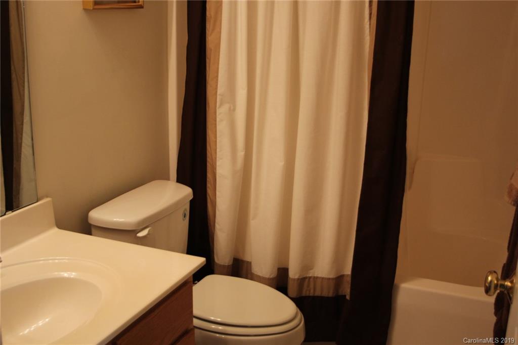 7539 Bluff Point Lane Denver, NC 28037 - Photo 25 of 30 a white toilet sitting next to a bathroom sink