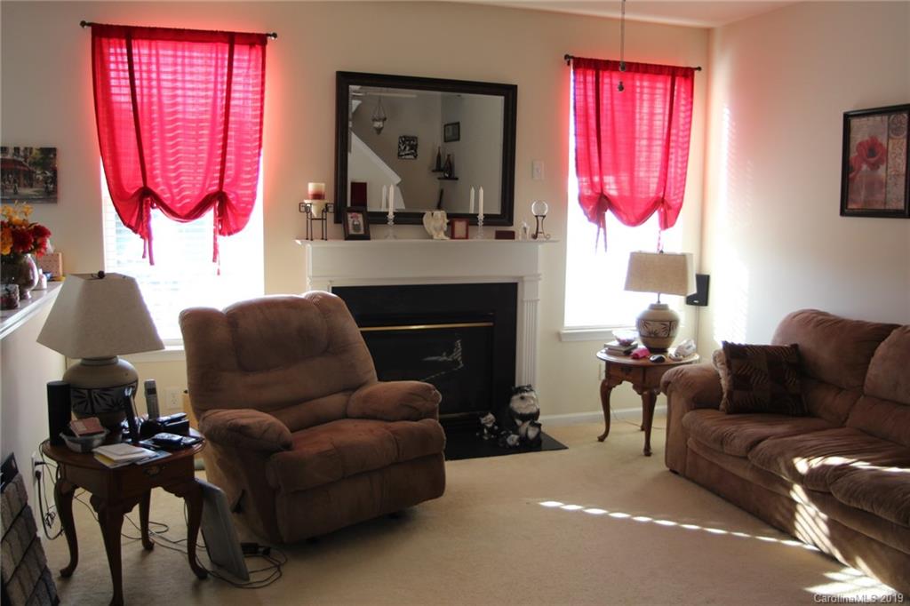 7539 Bluff Point Lane Denver, NC 28037 - Photo 9 of 30 a living room with furniture and a fireplace