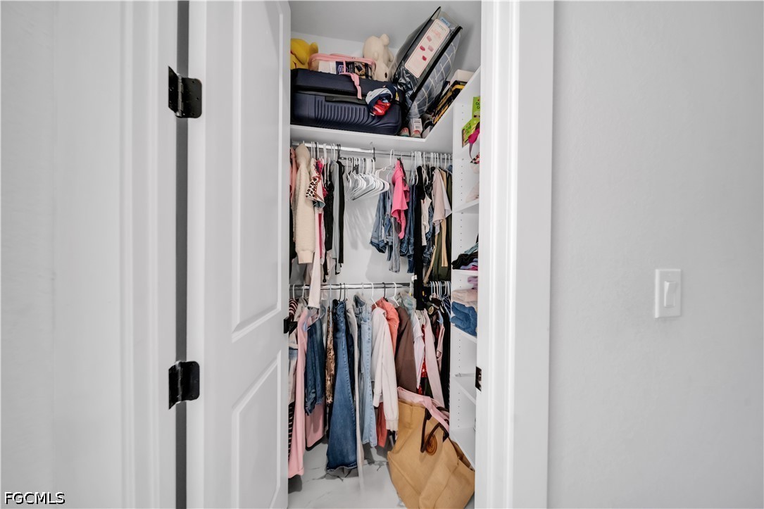 1128 Nelson Road North Cape Coral, FL 33993 - Photo 14 of 22 a view of walk in closet with clothes and shoes