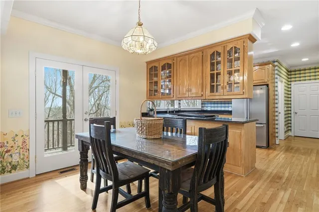 a kitchen with stainless steel appliances granite countertop a refrigerator and a stove top oven