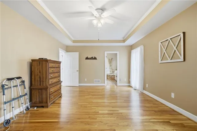a spacious bathroom with a granite countertop sink a large mirror and a shower