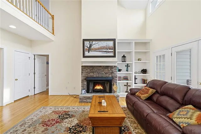 a living room with furniture a table and a large window