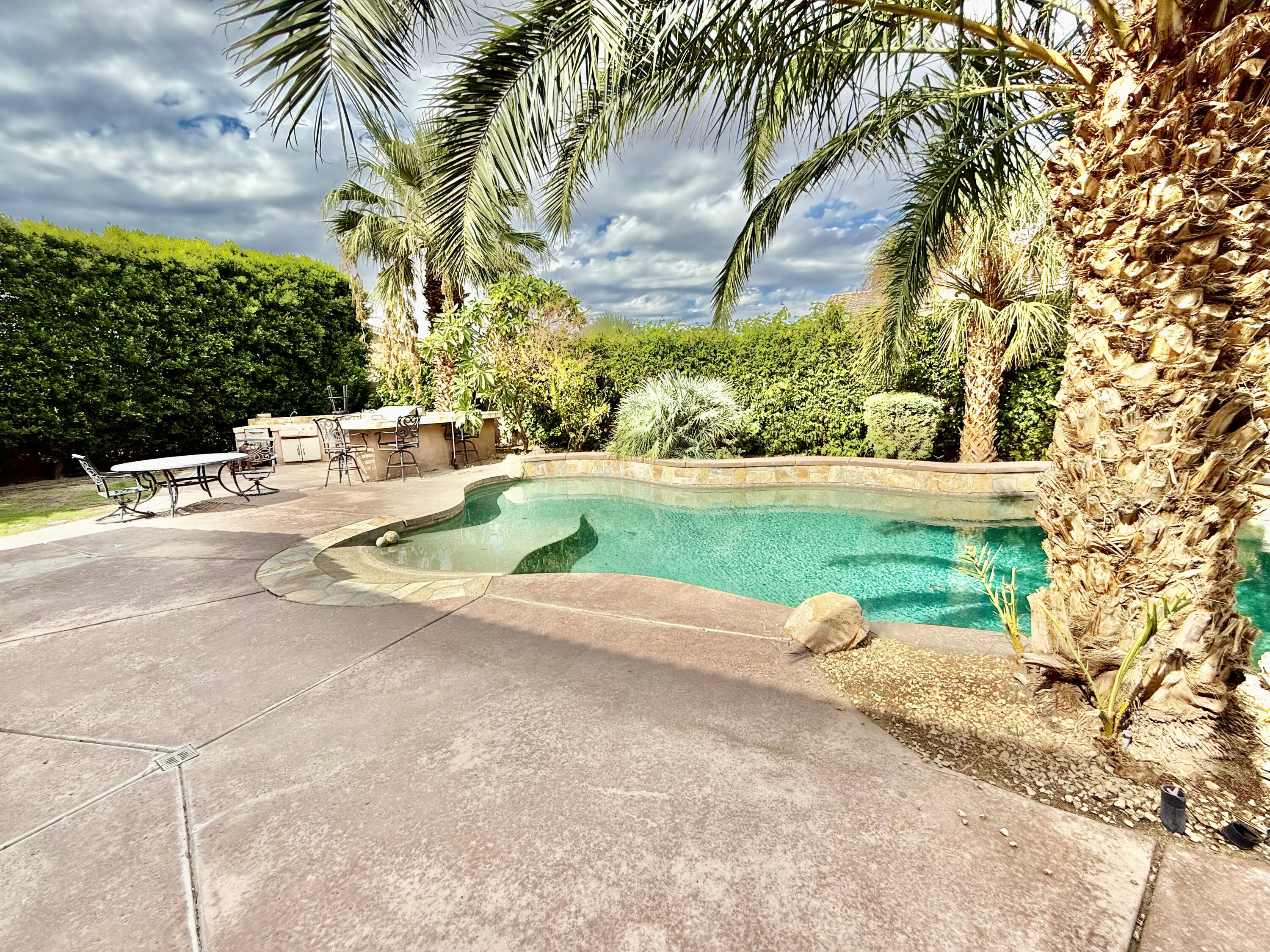 82546 Tivoli Court Indio, CA 92203 - Photo 12 of 19 a white house with a yard and palm trees