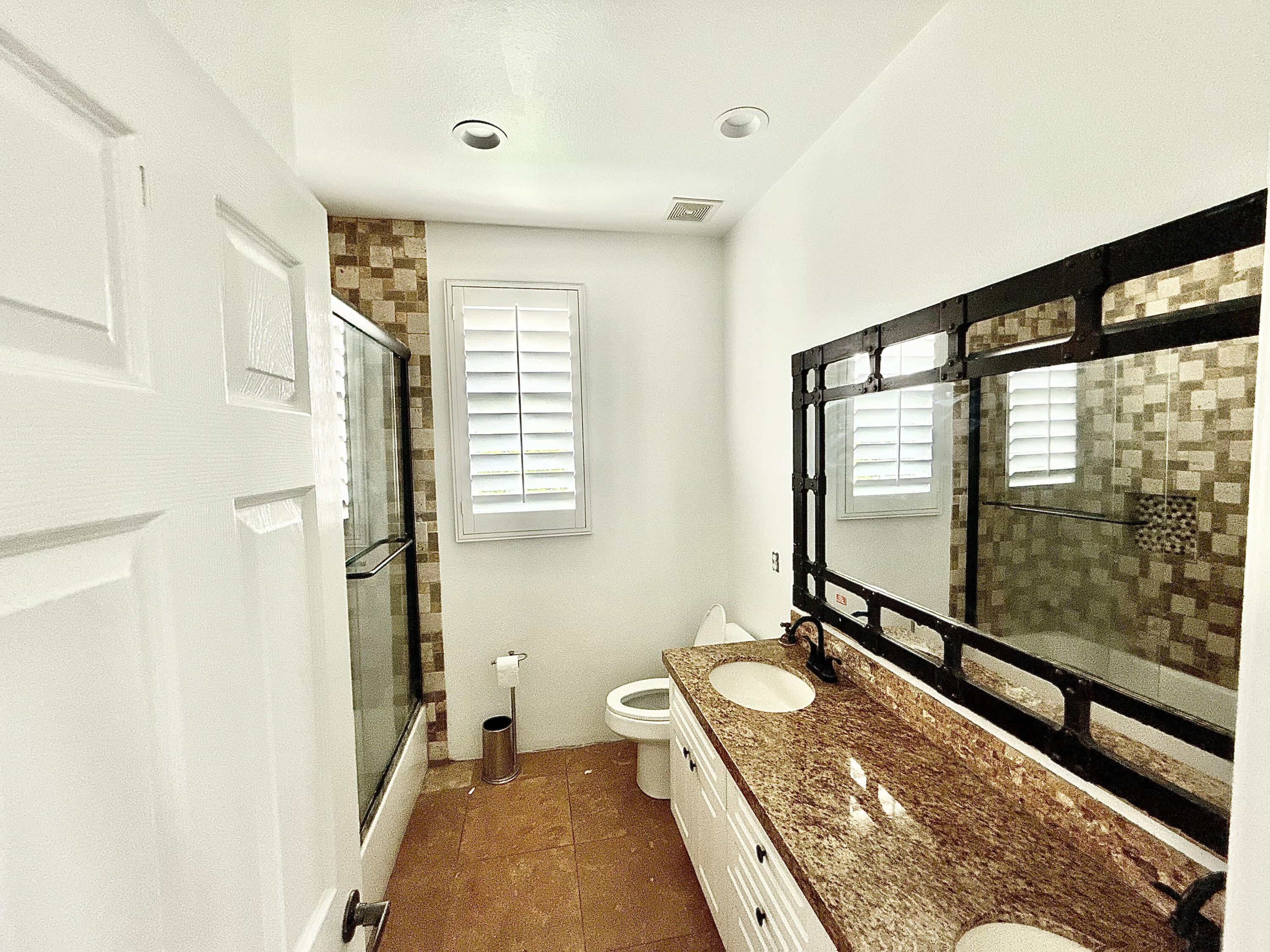 82546 Tivoli Court Indio, CA 92203 - Photo 14 of 19 a bathroom with a granite countertop sink a toilet a mirror and shower