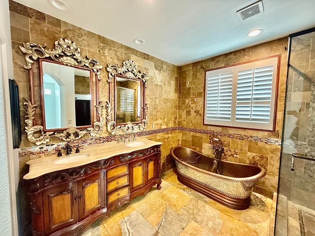 a bathroom with a tub sink and mirror