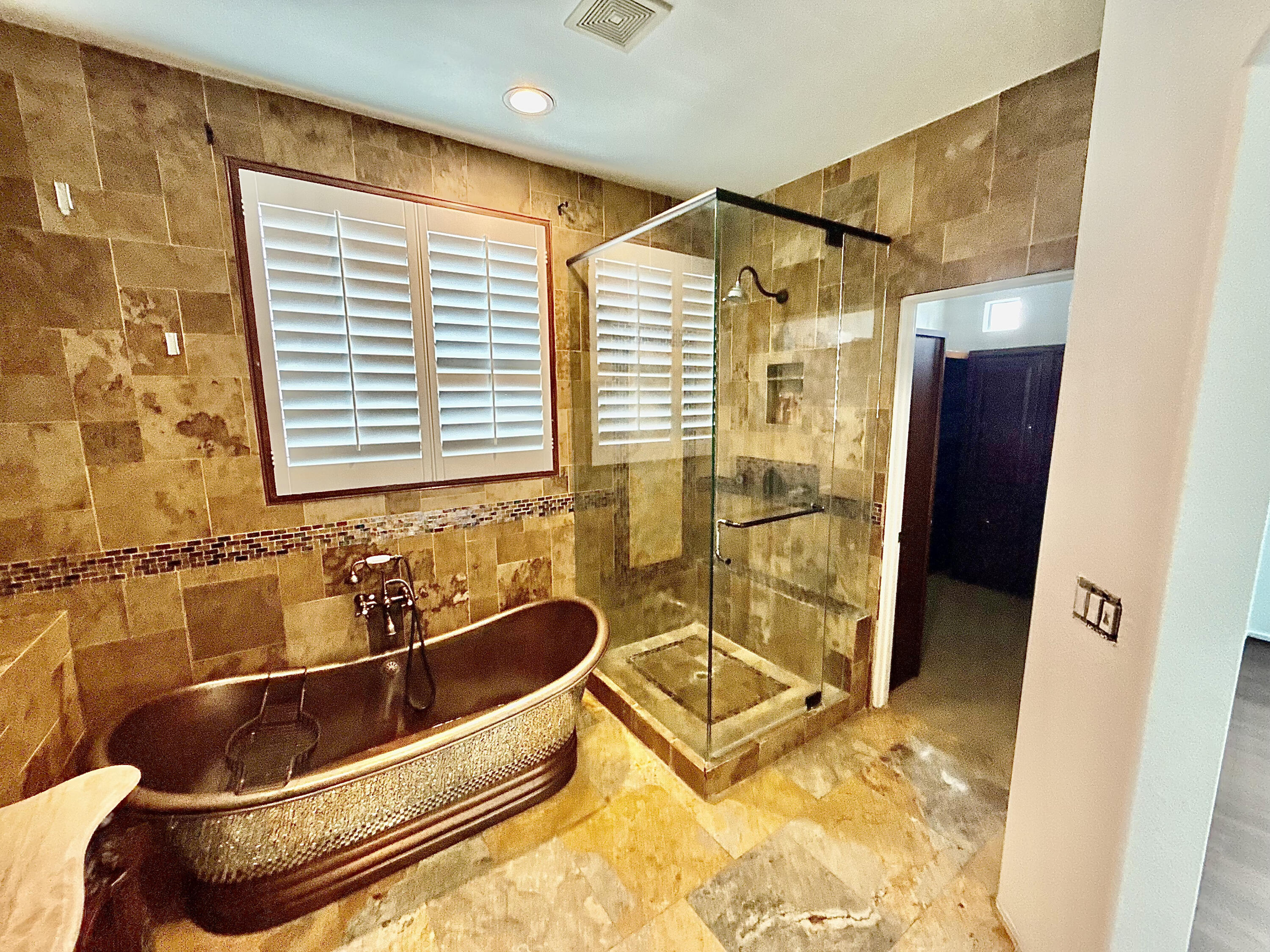 82546 Tivoli Court Indio, CA 92203 - Photo 16 of 19 a bathroom with a tub a sink and a shower