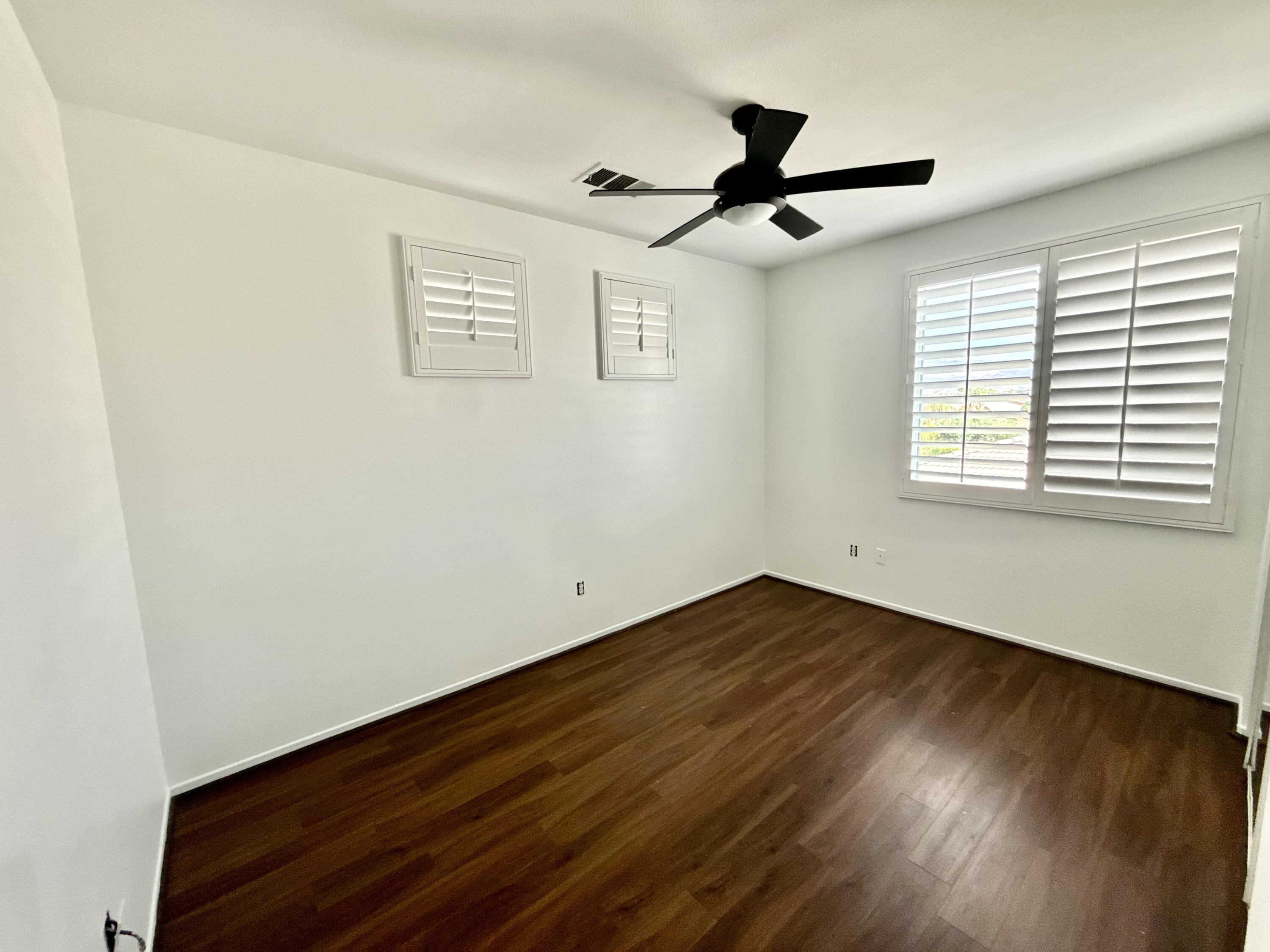 82546 Tivoli Court Indio, CA 92203 - Photo 18 of 19 a view of empty room with wooden floor and fan