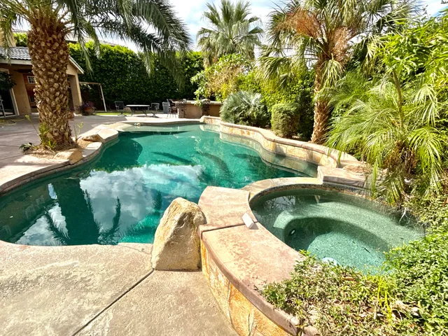a view of swimming pool from a garden