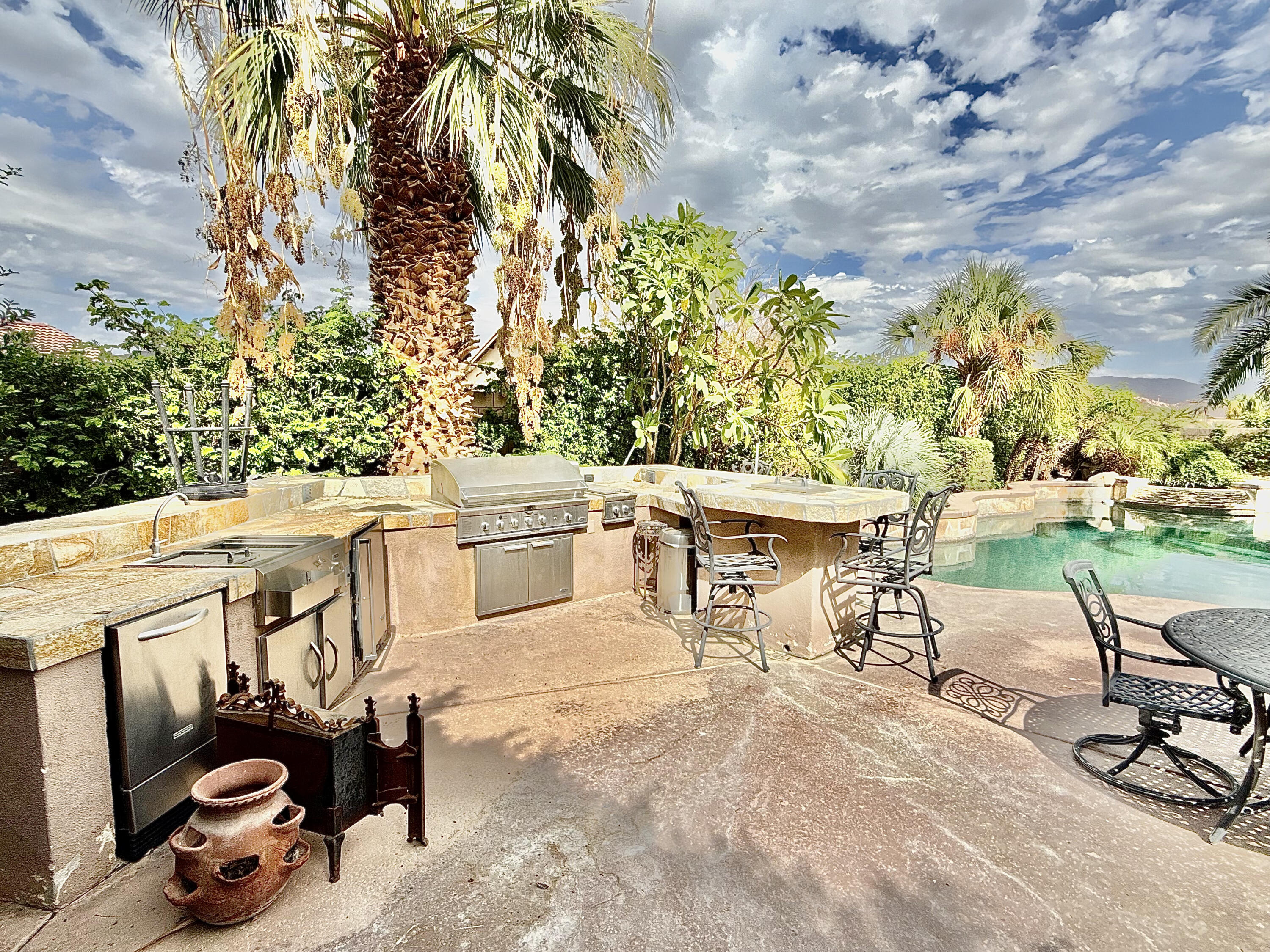82546 Tivoli Court Indio, CA 92203 - Photo 5 of 19 a view of a patio with table and chairs and couches with wooden fence