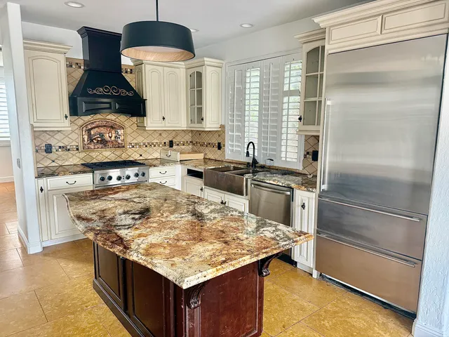 a kitchen with a stove and a refrigerator