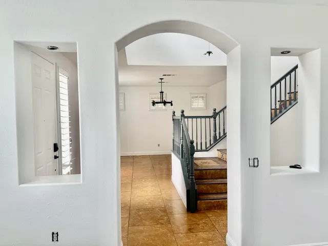 a view of a hallway with entryway wooden floor and front door