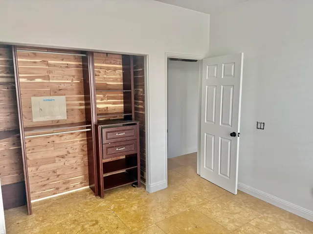 a view of walk in closet with empty racks