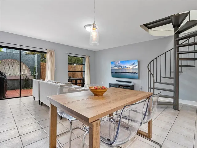a view of a dining room with furniture and a chandelier