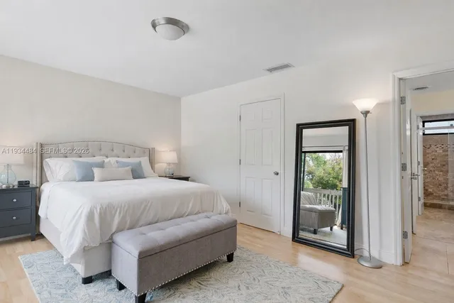 a bedroom with a bed and a mirror