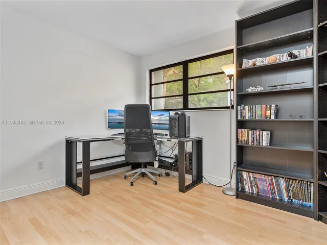 a room with furniture and view of kitchen