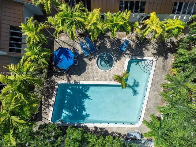 an aerial view of residential house with outdoor space and trees all around