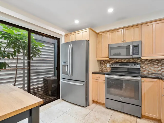 a kitchen with stainless steel appliances a stove sink and microwave