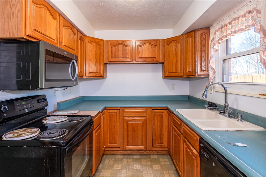 5760 Kitridge Road Dayton, OH 45424 - Photo 5 of 19 This kitchen features a practical layout with ample cabinetry and a window offering natural light.