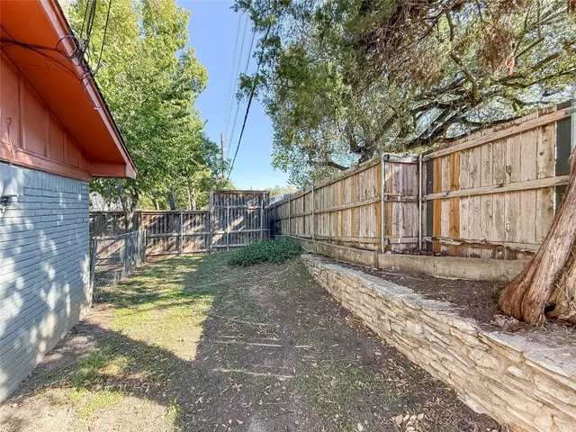 a view of a backyard with a tree