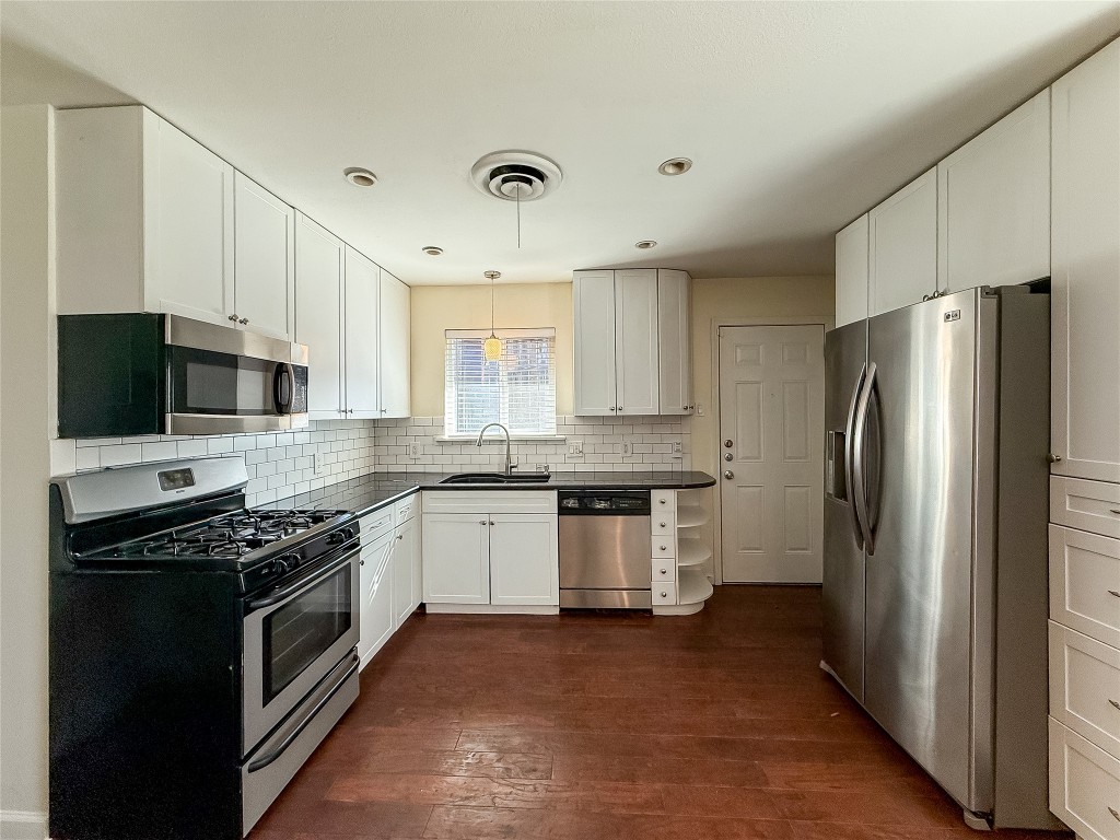 2309 Alta Vista Avenue, Unit B Austin, TX 78704 - Photo 8 of 19 a kitchen with stainless steel appliances granite countertop a stove top oven a refrigerator and a sink