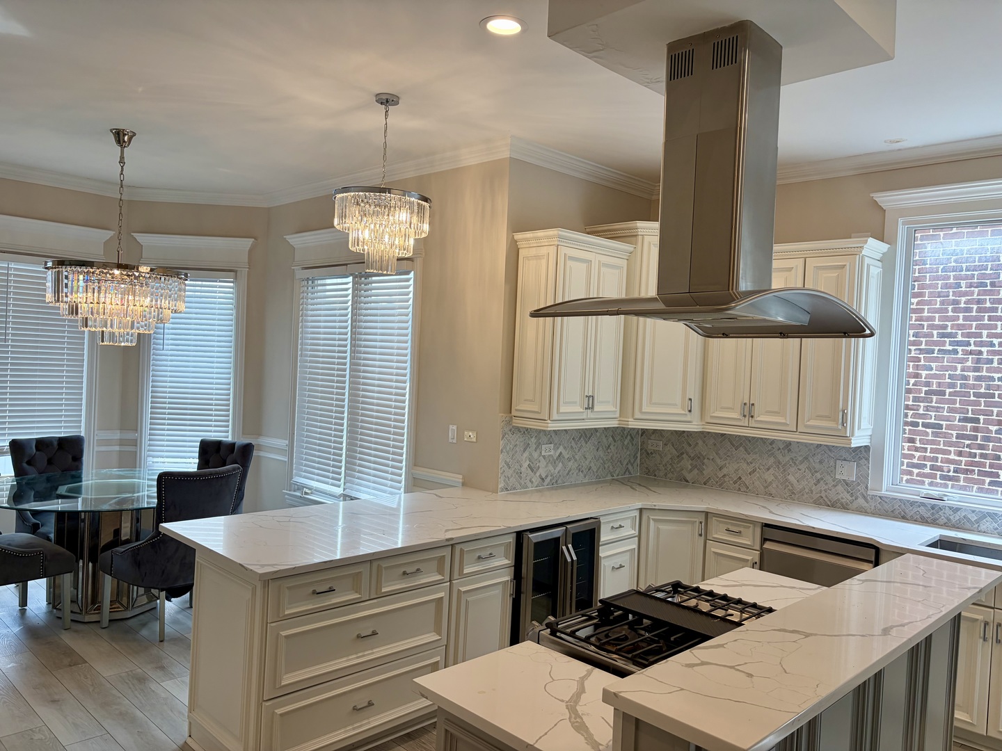 7381 South Madison Street Burr Ridge, IL 60527 - Photo 13 of 30 a kitchen with a stove a sink a dining table and chairs
