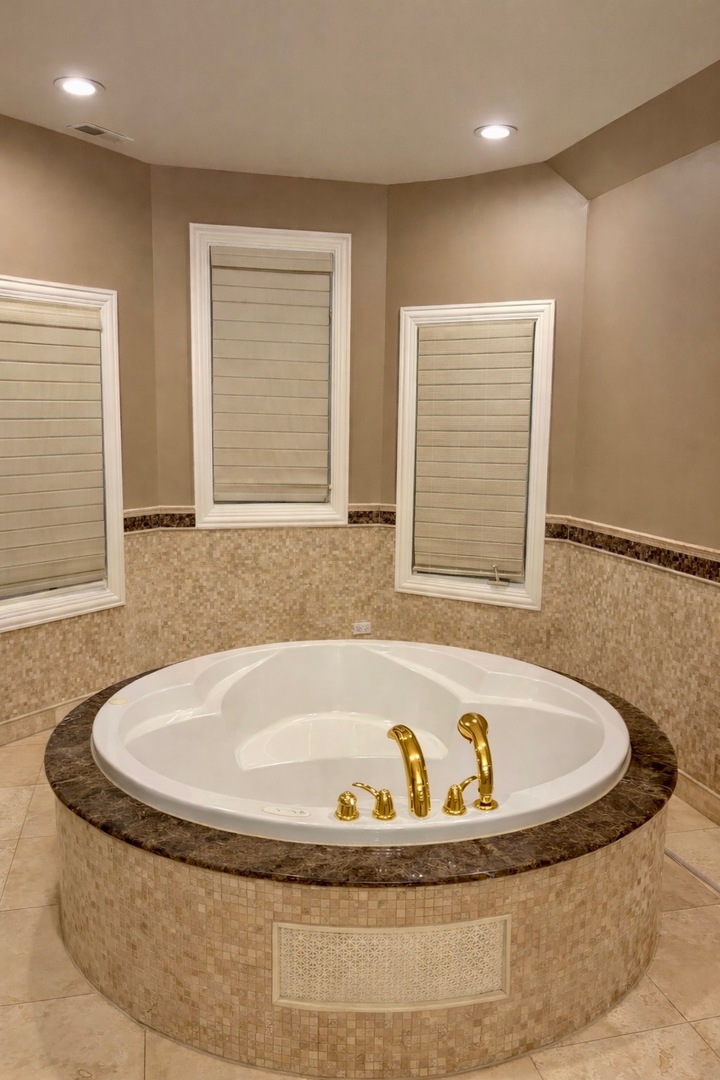 7381 South Madison Street Burr Ridge, IL 60527 - Photo 19 of 30 a bath tub sitting in a bathroom next to a window