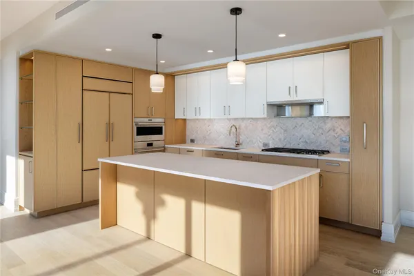 a kitchen with stainless steel appliances granite countertop a sink a stove and a refrigerator