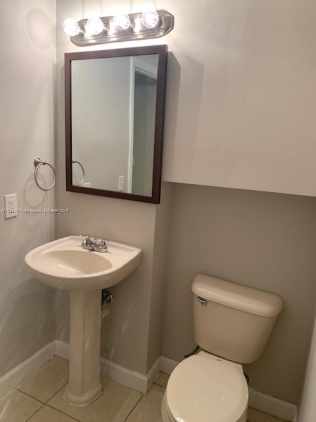Silver Palm Homes Miami, FL 33170 - Photo 12 of 32 a bathroom with a toilet a sink and mirror