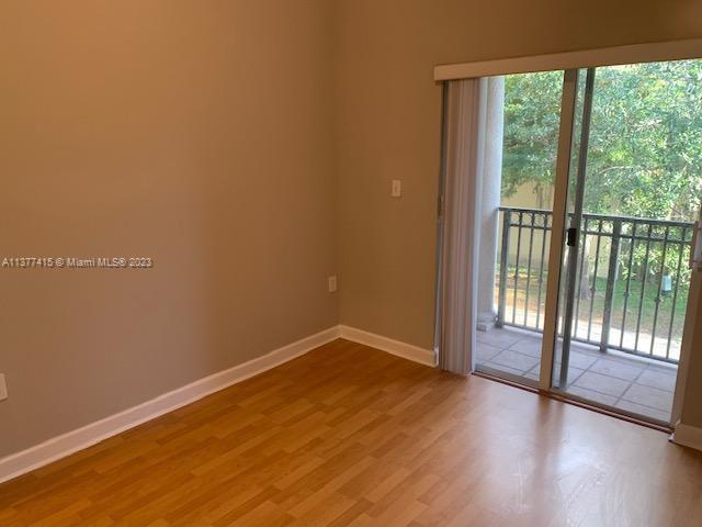Silver Palm Homes Miami, FL 33170 - Photo 23 of 32 a view of empty room with wooden floor and floor to ceiling window