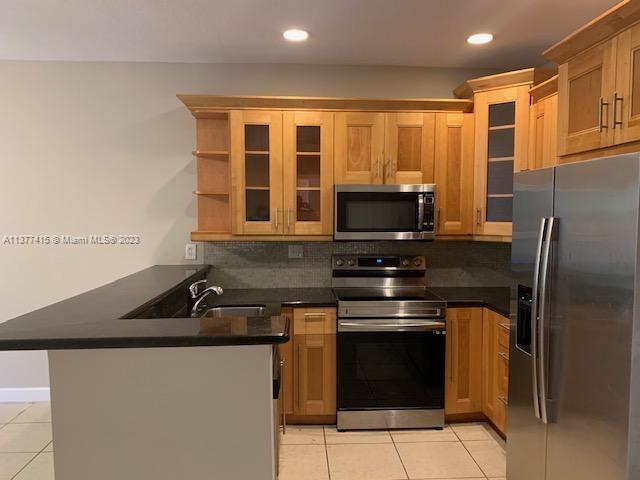 Silver Palm Homes Miami, FL 33170 - Photo 6 of 32 a kitchen with a sink stove and microwave