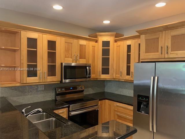 Silver Palm Homes Miami, FL 33170 - Photo 7 of 32 a kitchen with stainless steel appliances granite countertop a refrigerator a stove and a sink with granite countertops