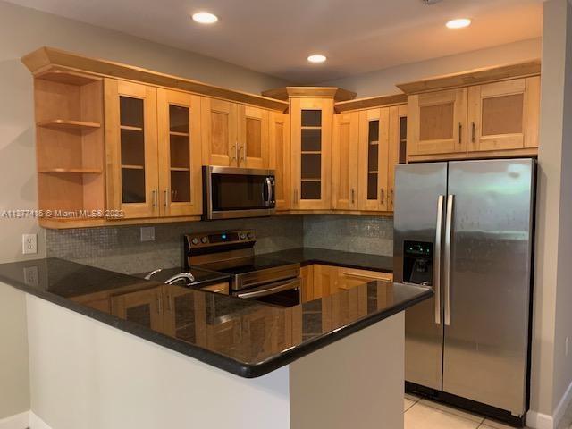Silver Palm Homes Miami, FL 33170 - Photo 8 of 32 a kitchen with stainless steel appliances granite countertop a sink a stove and a refrigerator