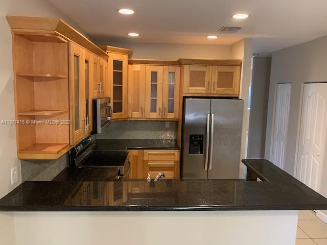 Silver Palm Homes Miami, FL 33170 - Photo 9 of 32 a kitchen with kitchen island a counter top space a sink a refrigerator and a window