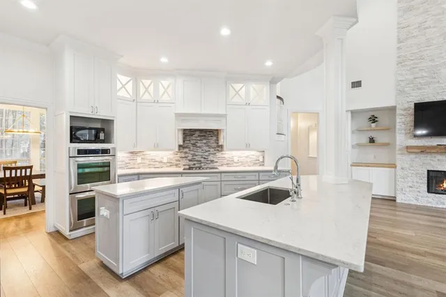a kitchen with cabinets a sink and appliances