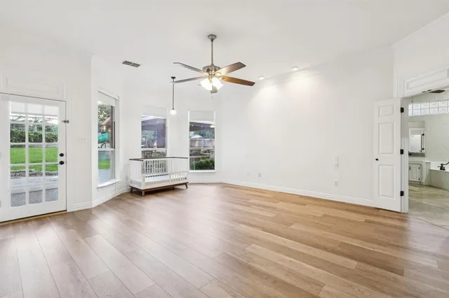 a view of a room with wooden floor and window