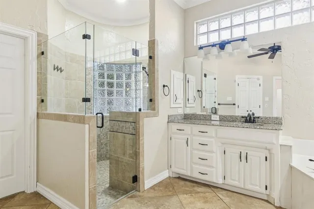 a bathroom with a granite countertop shower sink and mirror