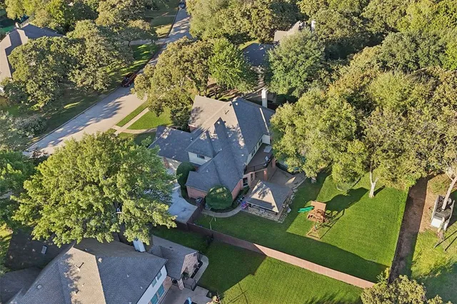 an aerial view of a residential houses with outdoor space