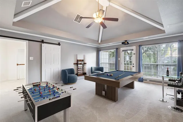 a living room with furniture and floor to ceiling windows