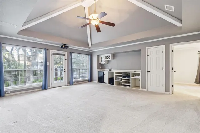 a view of an empty room with a fireplace and a large window