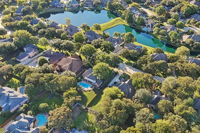 an aerial view of a houses with yard