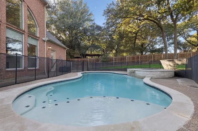 a view of a swimming pool with a backyard