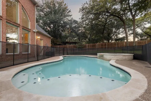 a view of a swimming pool with a yard