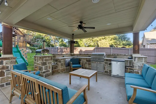 a view of a chairs and table in patio with a barbeque