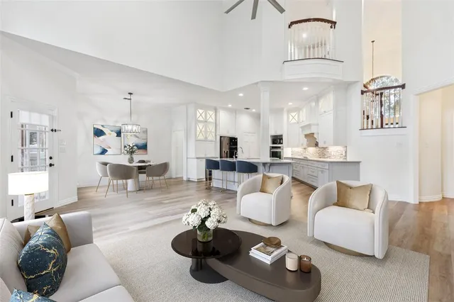 a living room with furniture and kitchen view