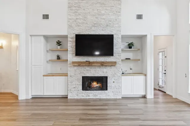 a living room with a fireplace and a flat screen tv