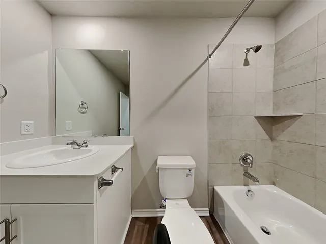 a bathroom with a sink and mirror with toilet