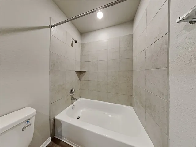 a bathroom with a bathtub and a toilet